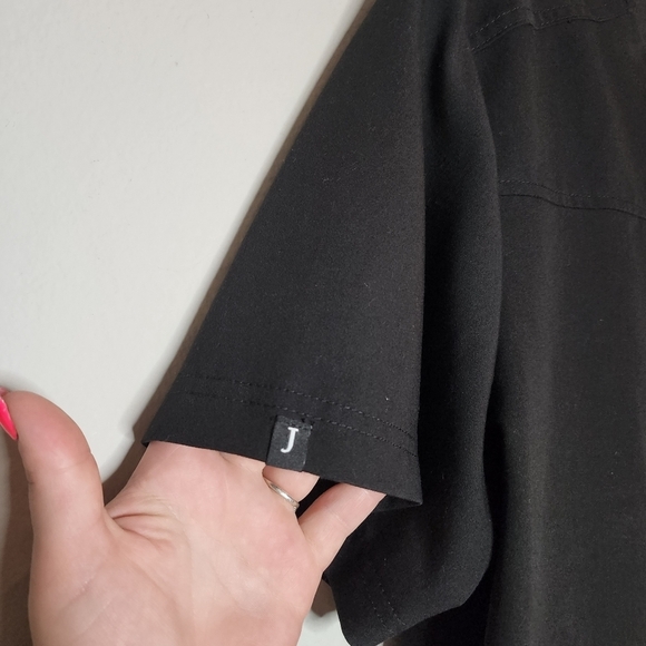 Jaanuu black scrub top. 1 zip chest pocket.  Short sleeve v-neck. Women's size L - Picture 6 of 14